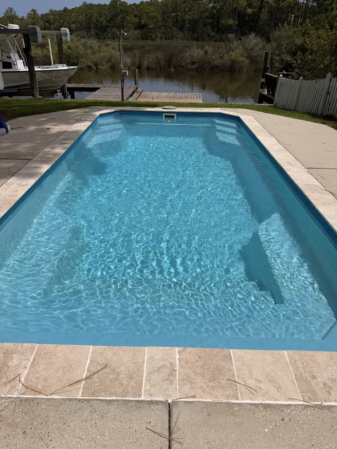 Waterfront pool maintained with clear blue water